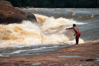 Un indígena lanza su atarraya a las turbulentas aguas del raudal Zamuro en el río Inírida, para capturar fácilmente los peces que tienen que nadar contra la corriente.